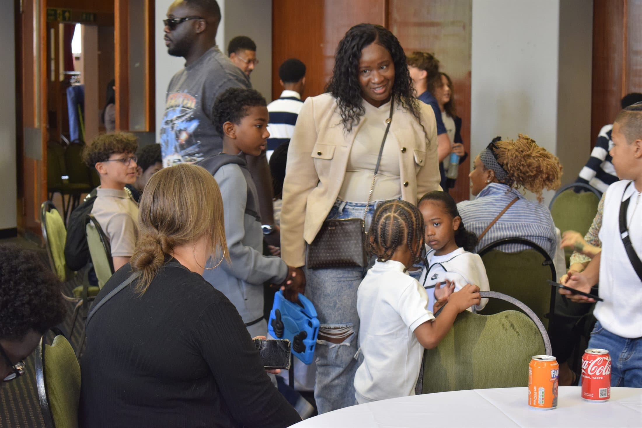 Families and young people talking at a community event