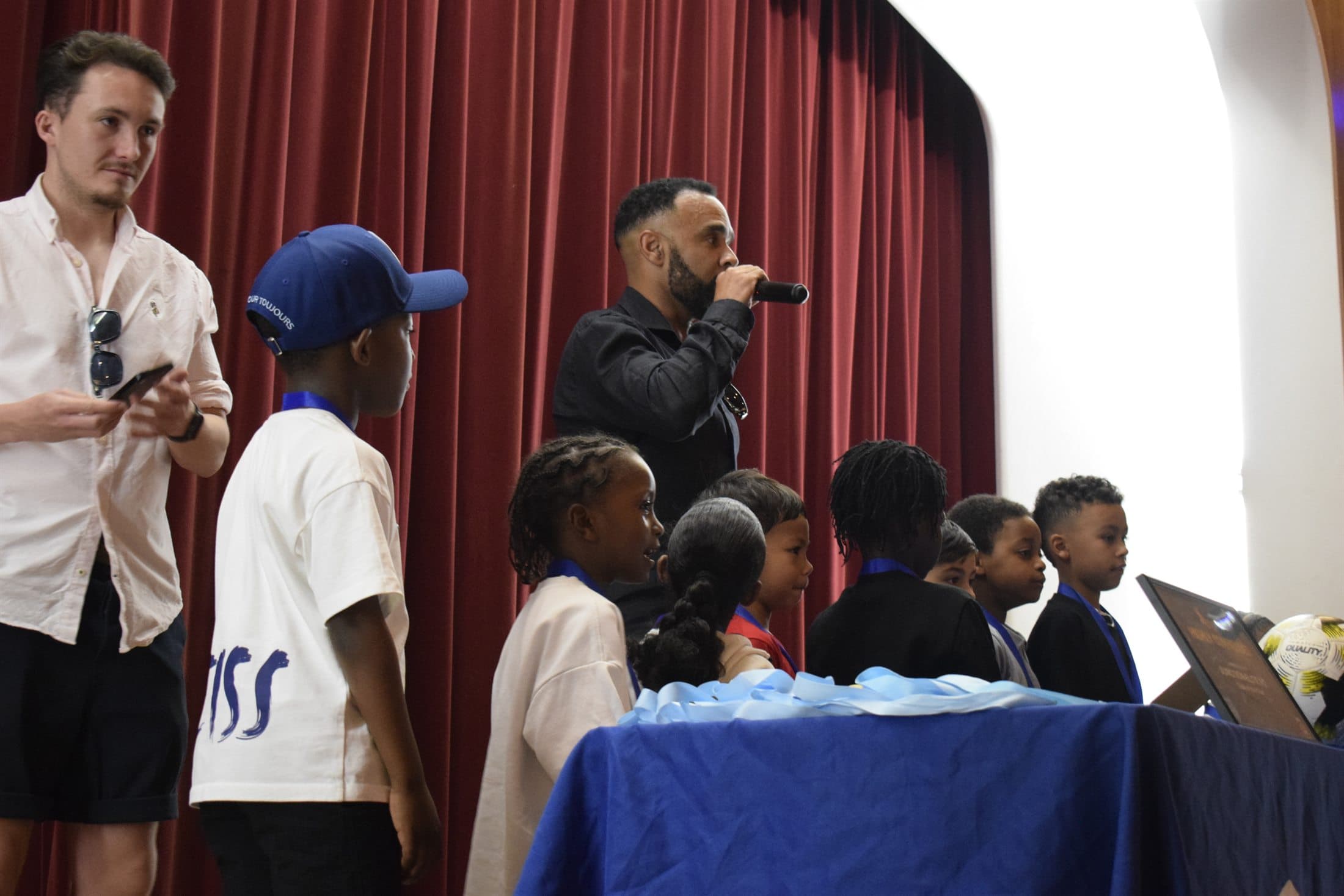 Young people receiving recognition on stage